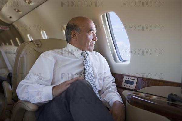 Hispanic businessman on private jet