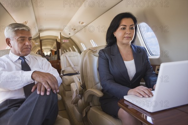 Business people working on private jet