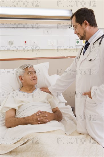 Doctor talking with patient in hospital room