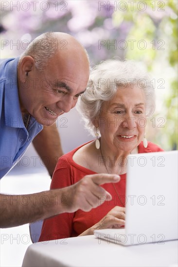 Senior Chilean couple using laptop