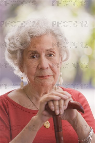 Smiling senior Chilean woman with cane