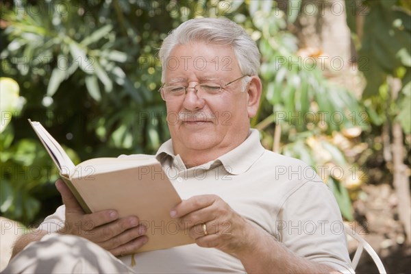 Senior Chilean man reading book