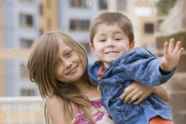 Chilean brother and sister hugging