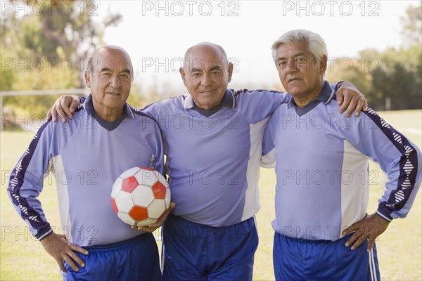 Senior Chilean soccer players standing together