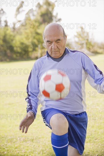 Senior Chilean soccer player bouncing soccer ball