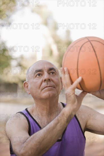 Senior Chilean man playing basketball