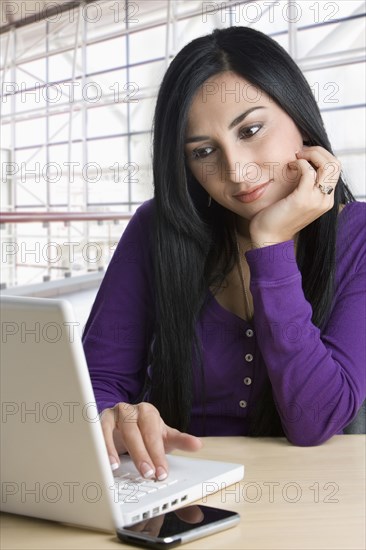 Turkish businesswoman typing on laptop