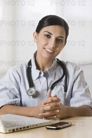Turkish doctor sitting in doctor's office