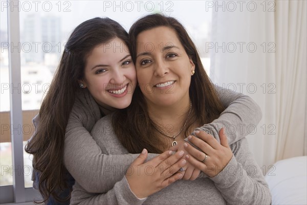 Chilean daughter hugging mother