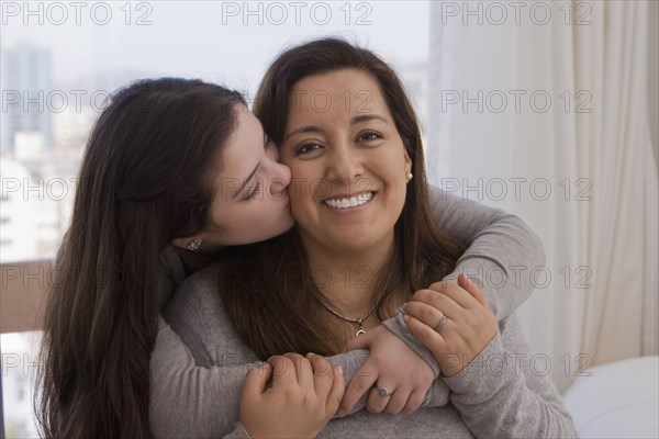 Chilean daughter kissing mother