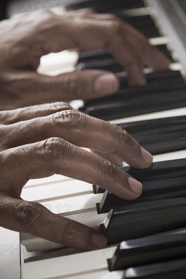 Mixed race man playing the piano