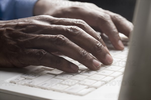 Mixed race man typing on laptop