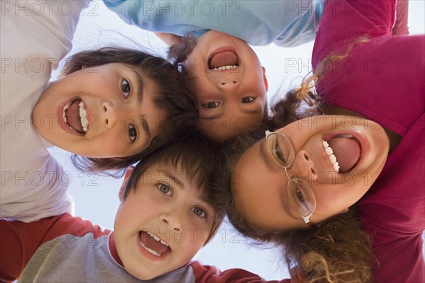 Hispanic children bending and looking down