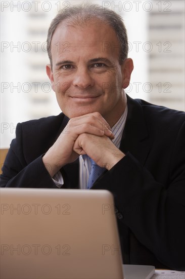 Chilean businessman sitting at desk