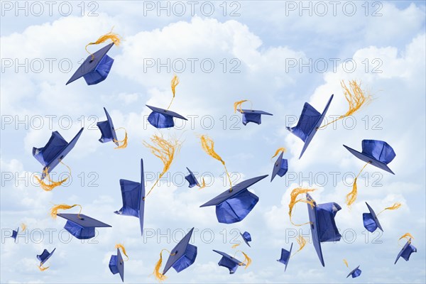 Graduation mortarboards being thrown in the air