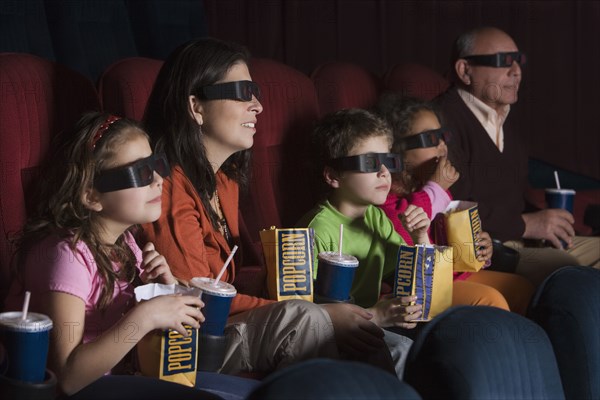 Hispanic family watching 3D movie