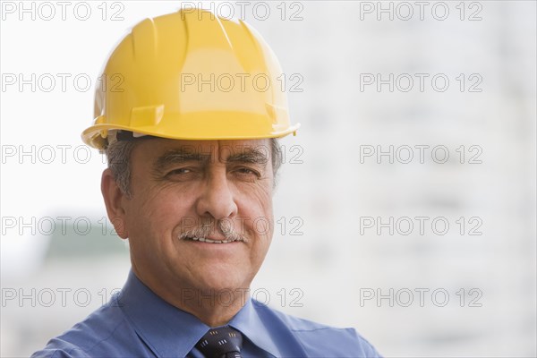 Hispanic businessman wearing hard hat