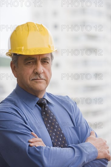 Hispanic businessman wearing hard hat