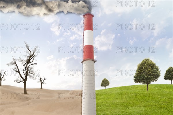 Smoke stack between desert and rural field