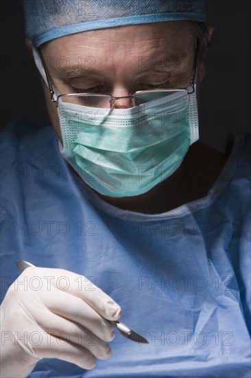 Caucasian surgeon performing surgery