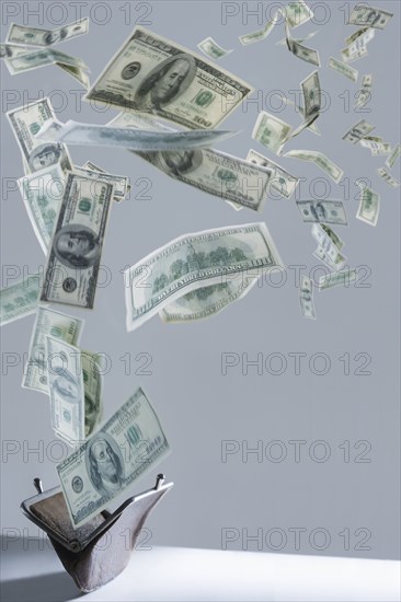 One hundred dollar bills floating out of purse