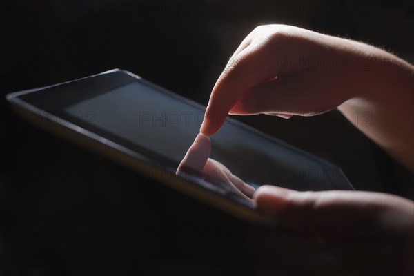 Close up of Hispanic girl using tablet computer