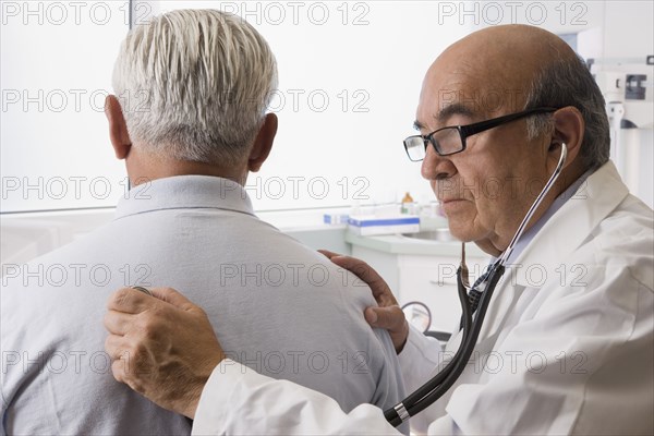 Hispanic doctor examining patient