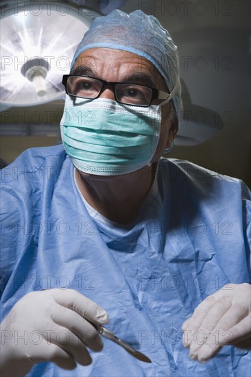 Hispanic surgeon working in operating room