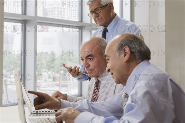 Hispanic doctors talking in office