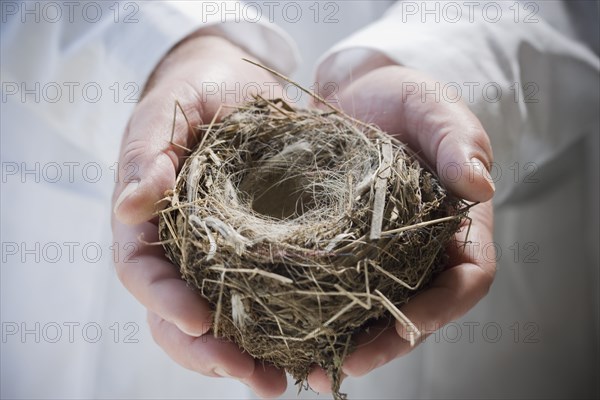 Hispanic man holding empty nest