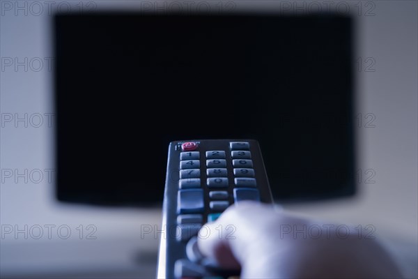 Hispanic man using remote control