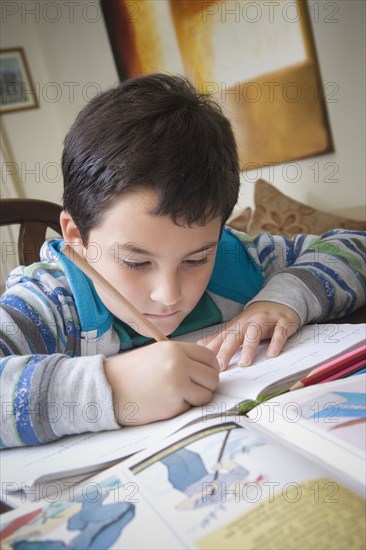 Hispanic boy doing homework at table