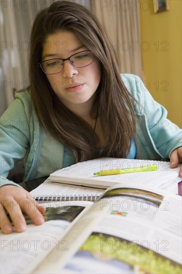 Hispanic girl doing homework at table