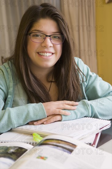 Hispanic girl doing homework at table