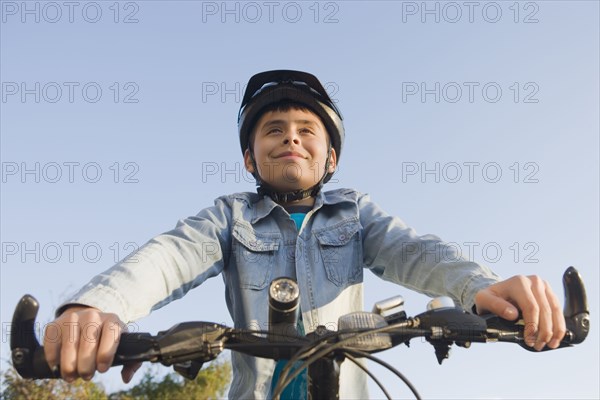 Hispanic boy riding bicycle