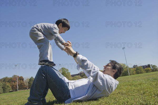 Hispanic father and son playing outdoors