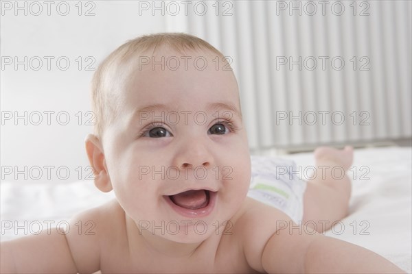 Hispanic baby boy laying on bed