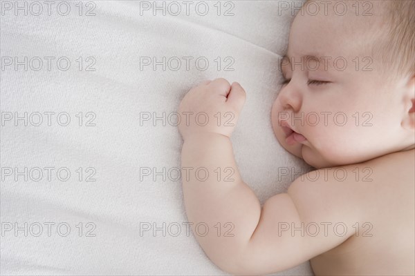 Hispanic baby boy sleeping on bed