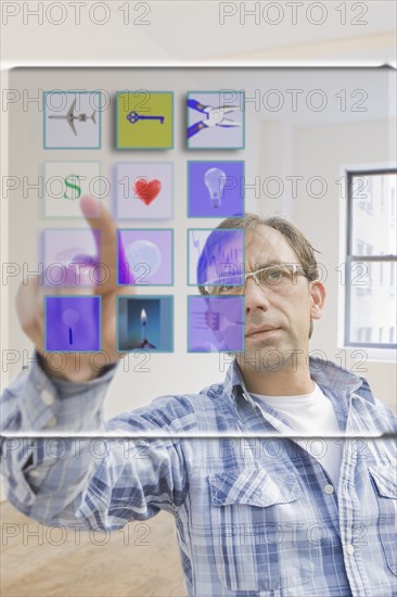 Hispanic man using mobile apps on virtual screen