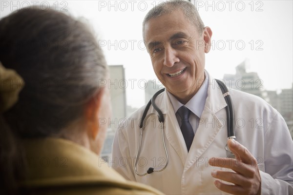 Hispanic doctor talking to patient