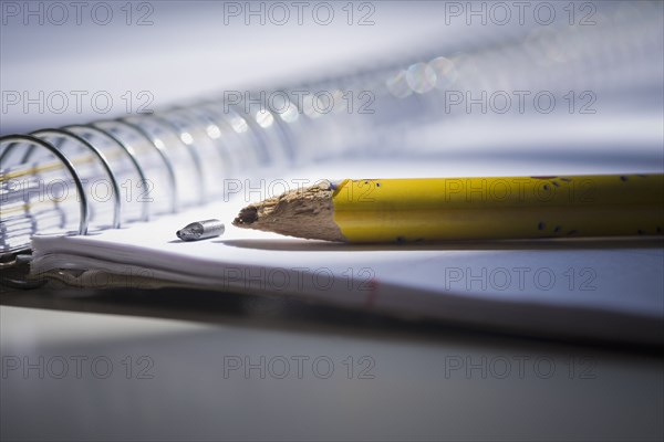 Close up of broken pencil on notebook