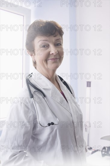 Hispanic doctor smiling in office