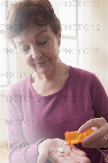 Hispanic woman taking medication