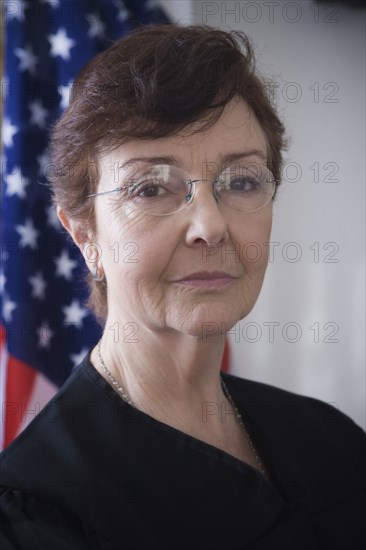 Hispanic judge posing by American flag