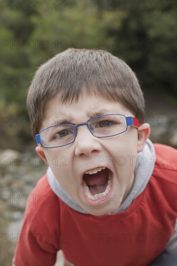 Hispanic boy screaming outdoors