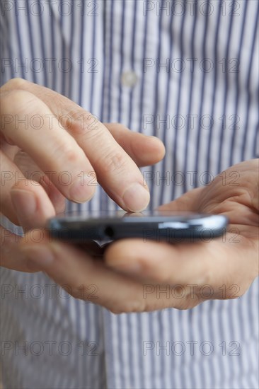 Close up of Hispanic senior man using cell phone