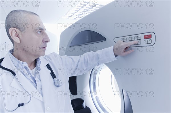 Hispanic doctor using MRI scanner
