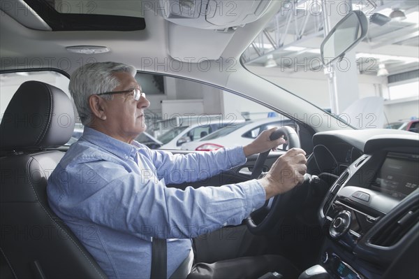 Hispanic customer test driving new car