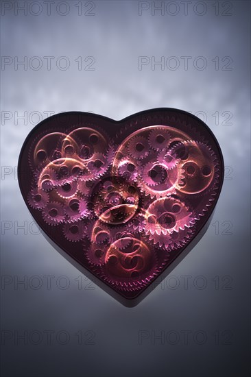 Mechanical gears turning in heart shape