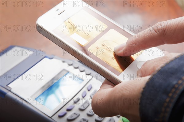 Hispanic woman paying with cell phone